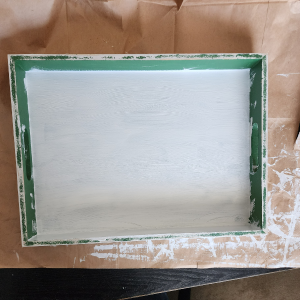 Green tray that's in the process of being painted white along with a valet that will be distressed and sold in GEM Designs, LLC booth at Antiques & Artisans, 619 Trolley Rd, Summerville in the room with the large Christmas tree.
