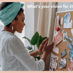 a woman standing in front of a cork vision board