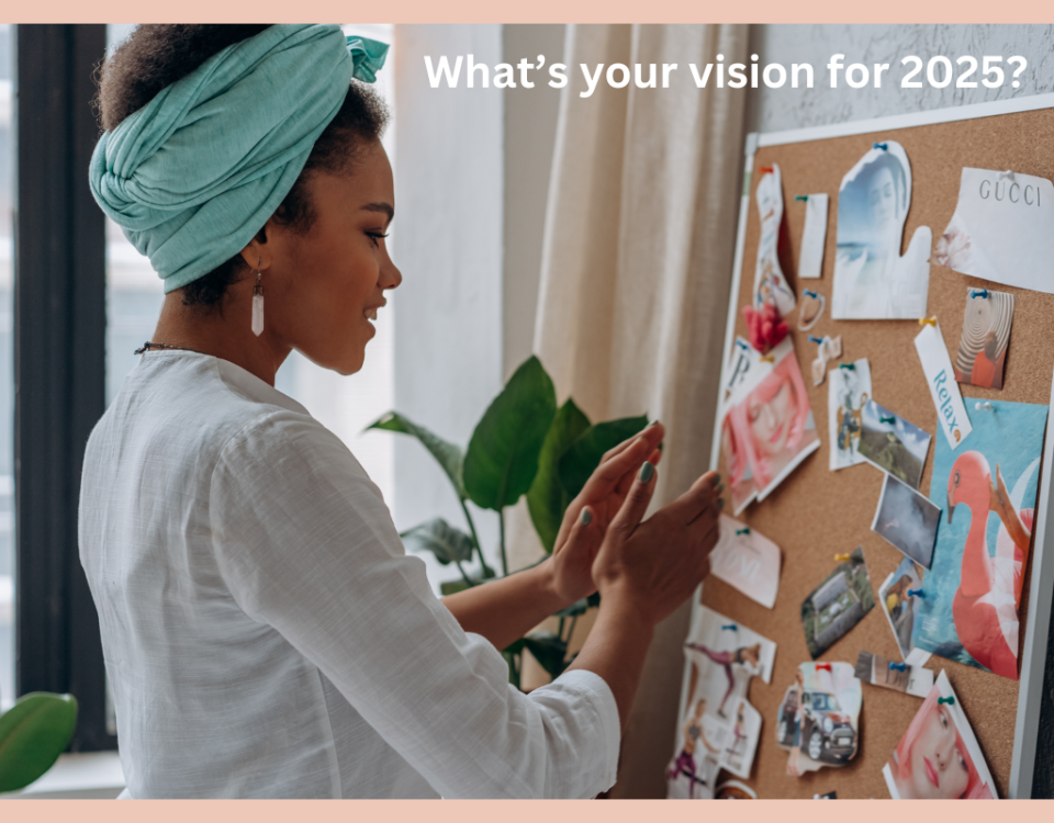 a woman standing in front of a cork vision board