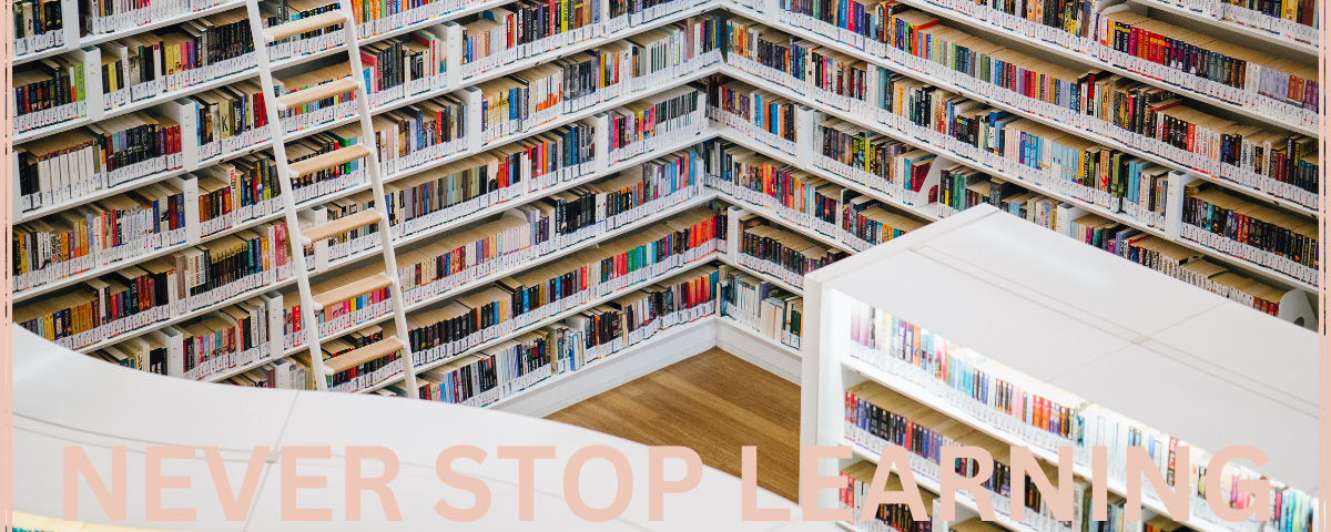 Picture of books in a library with the words never stop learning