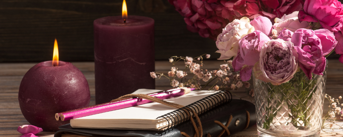 Journal, pen, candles and flowers