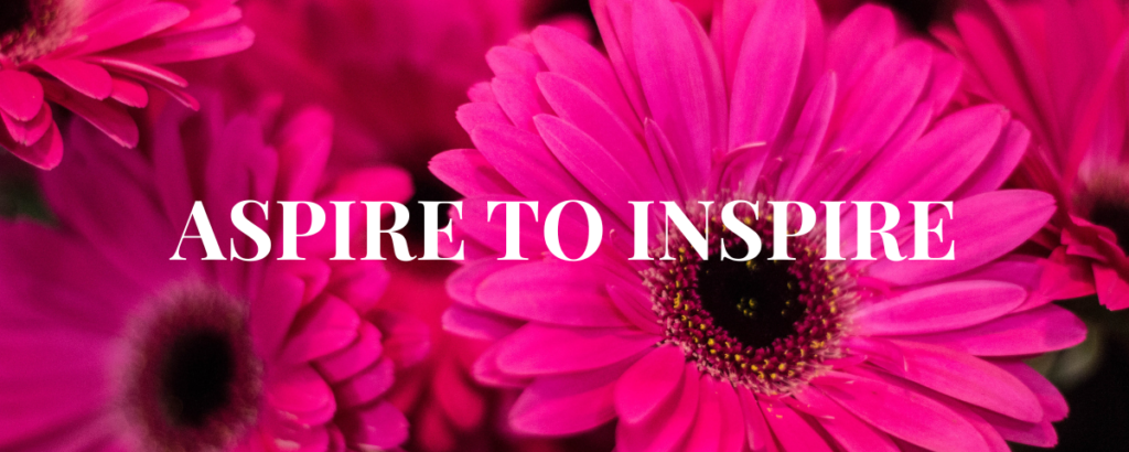 Aspire to Inspire words with Pink gerbera daisies background