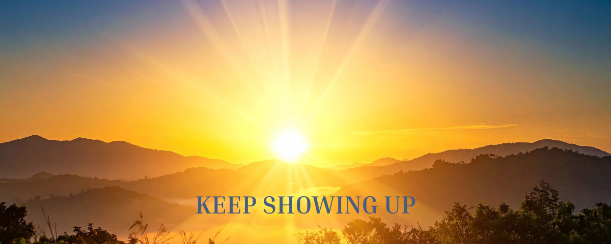 A picture of a sunrise with the words Keep Showing Up on it. nspirational image representing the power of showing up consistently and making progress through daily effort.